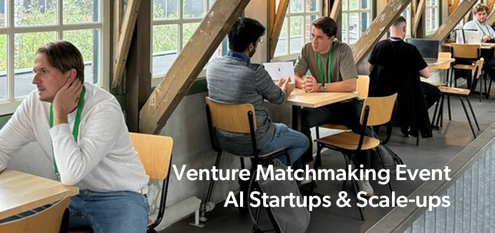 Deelnemers in gesprek tijdens het Venture Matchmaking Event voor AI-startups en scale-ups in een moderne ontmoetingsruimte.